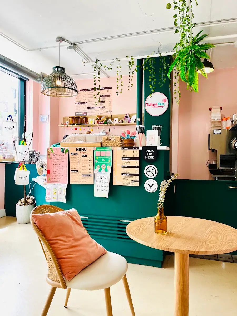 Pink walls and the forest-green counter inside the shop
