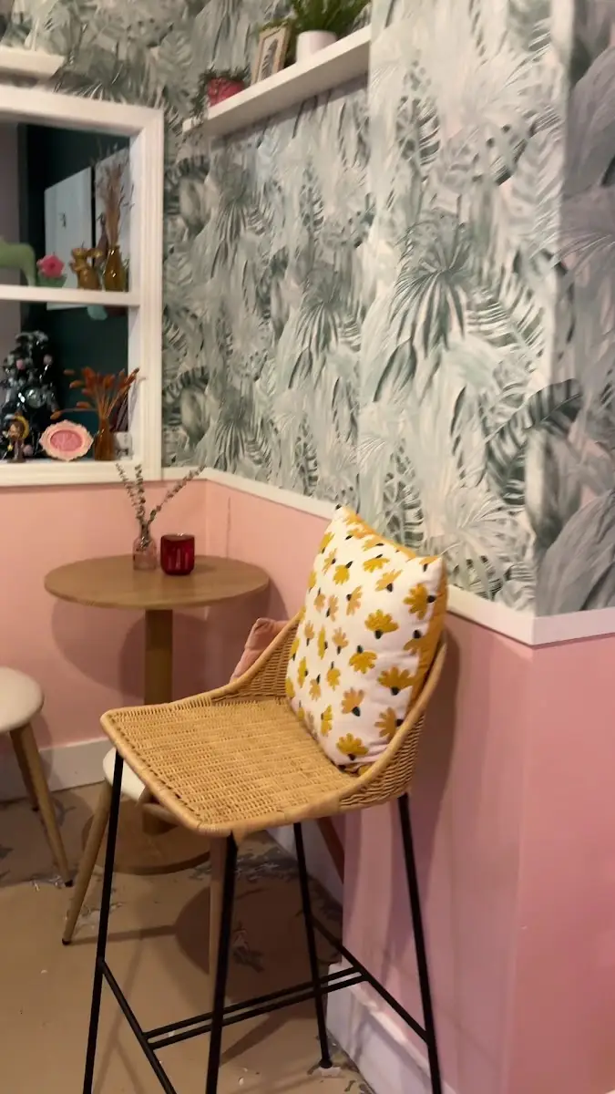 Rattan chair and a little table against the pink wall