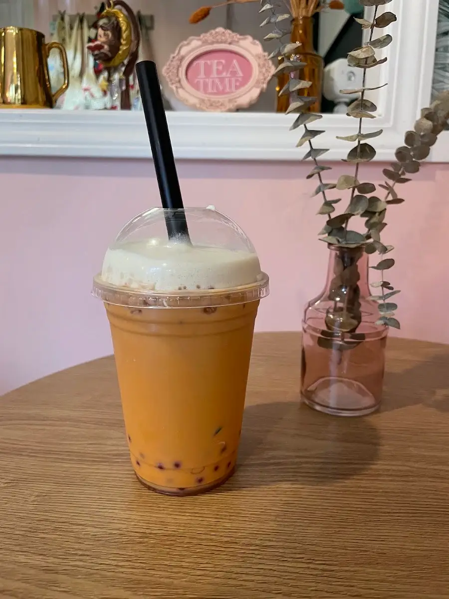 Caramel Thai milk tea with boba on a wooden table